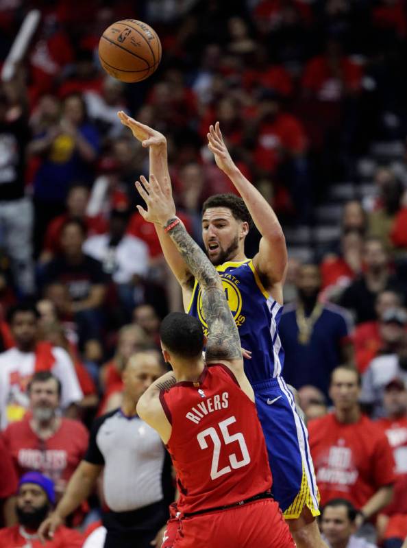 Golden State Warriors guard Klay Thompson (11) passes the ball over Houston Rockets guard Austi ...