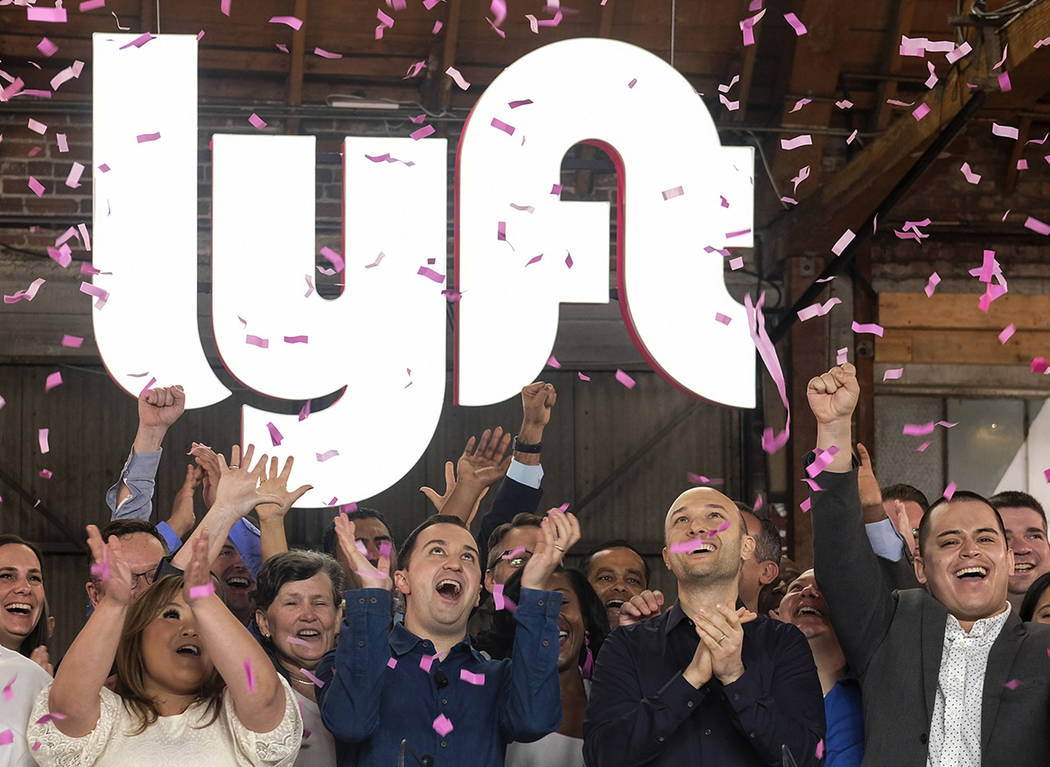 In this Friday, March 29, 2019 file photo, Lyft co-founders John Zimmer, front second from left ...