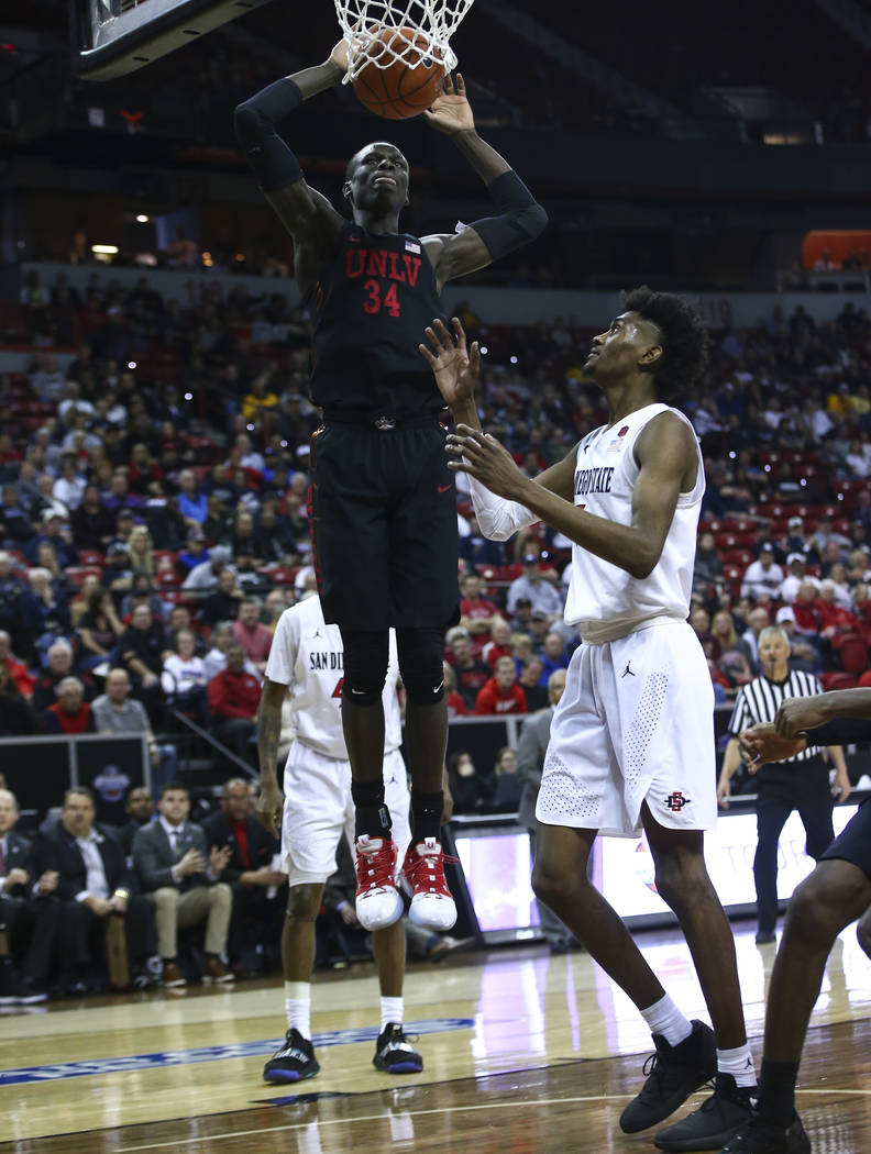 UNLV Rebels forward Cheikh Mbacke Diong (34) dunks over San Diego State Aztecs forward Jalen Mc ...