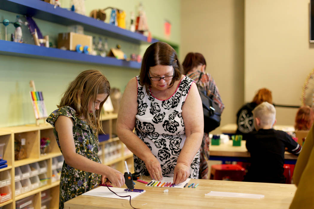 Sandy Windom works on crayon art that will be melted with her granddaughter Cara McAnallen, 9, ...