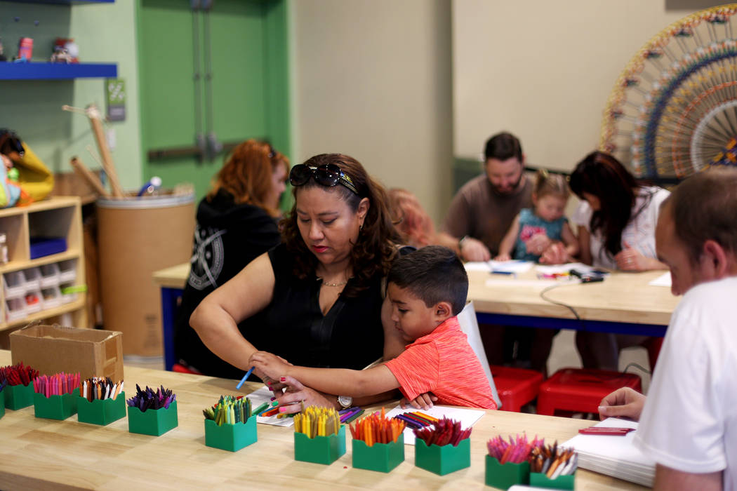 Maria Tawresey works on crayon art that will be melted with her son Zachary Tawresey, 5, at the ...