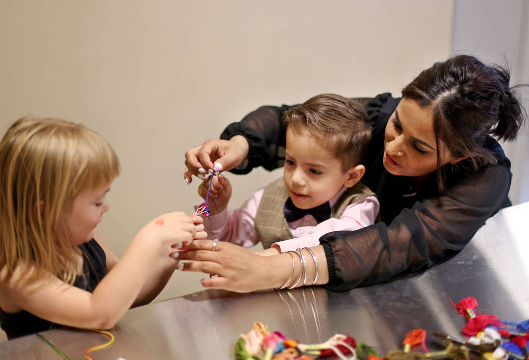 Noah Vidmar, 4, works on a friendship bracelet with his mom Natasha Vidmar and friend Penny Jon ...