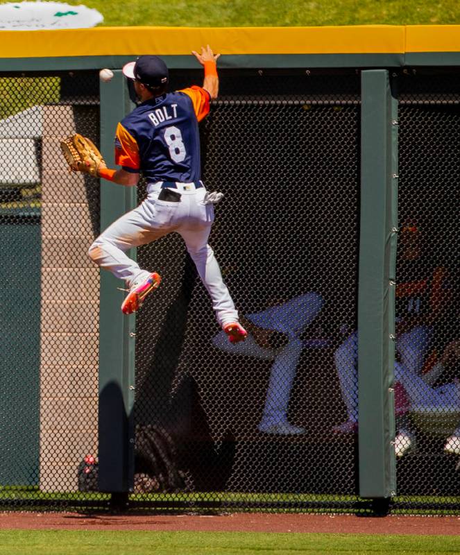 The Aviators Skye Bolt (8) attempts to catch a ball deep in right field hit off the wall by the ...