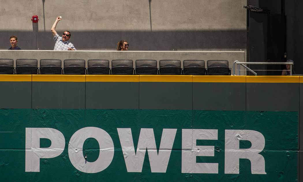 An Aviators fan shows off the ball he snagged which was hit over the wall in center field durin ...