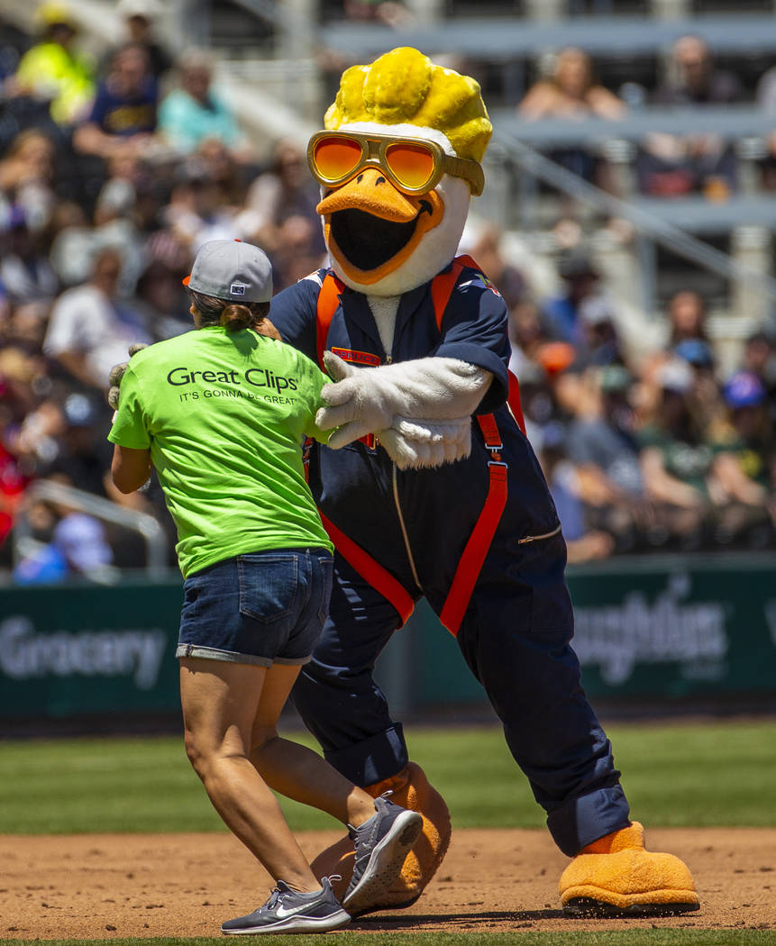 Puddles the Duck attempts to slow down Erica Haskin as they race around the bases while the Avi ...