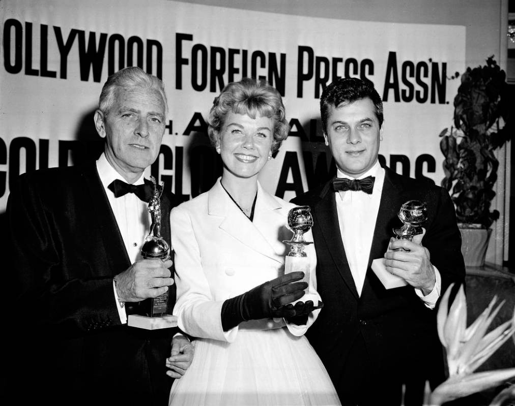 Actress Doris Day, center, Tony Curtis, right, and Buddy Adler pose with their awards presented ...