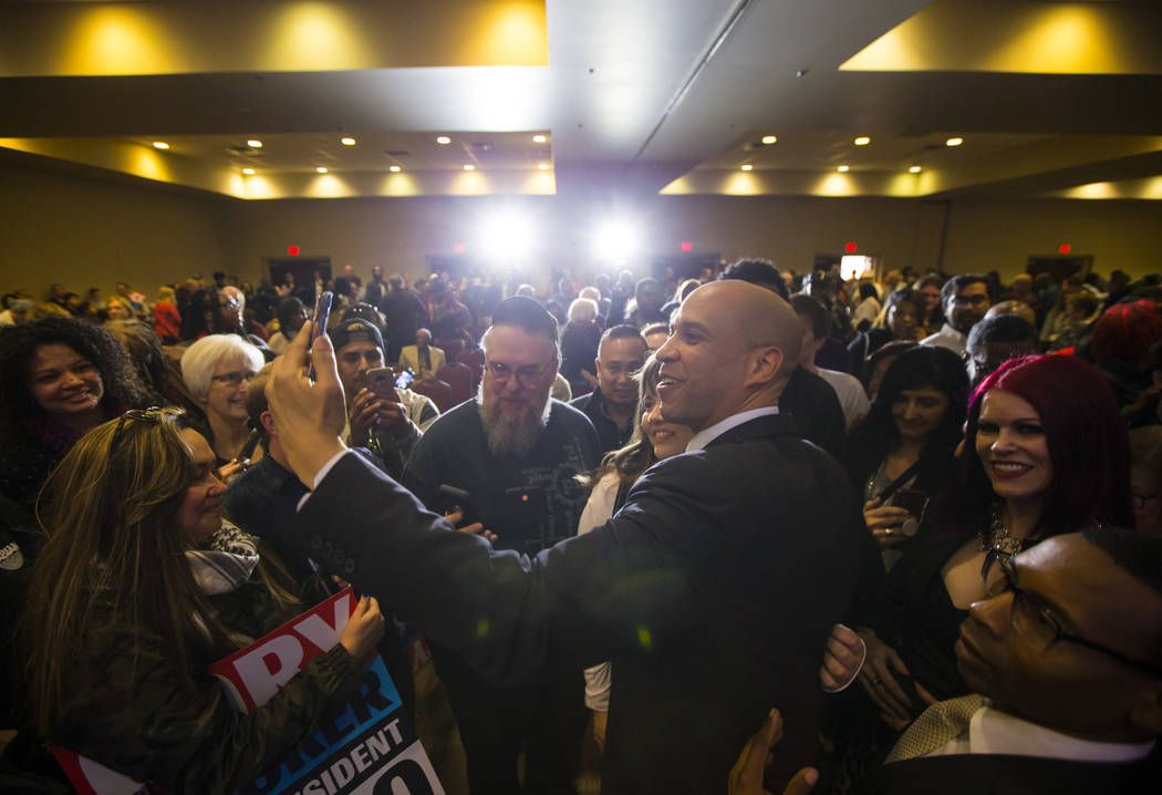 U.S. Sen. Cory Booker, D-N.J., a Democratic presidential hopeful, takes a selfie while greeting ...