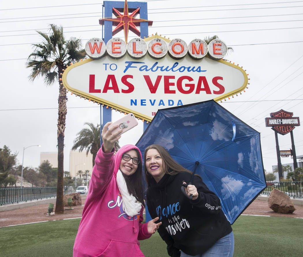 Heavy rain doesn't stop Estefania Vazquez, left, and Valeria Vazquez, from Escondido, Calif., f ...