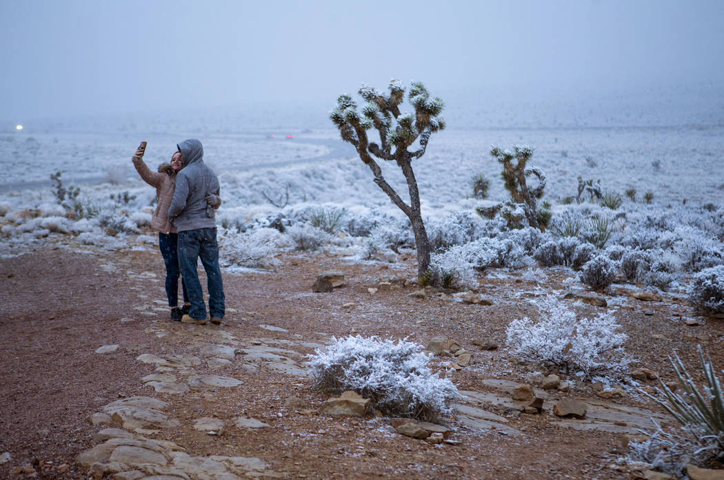 Candace Reid, of Albuquerque, N.M., left, takes a selfie with James Minner, of Las Vegas, as sn ...