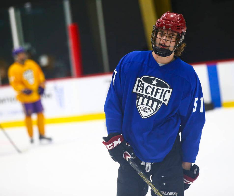 Team Blue's Matthew Gross (51) moves the puck against Team Yellow during a game in the USA Hock ...