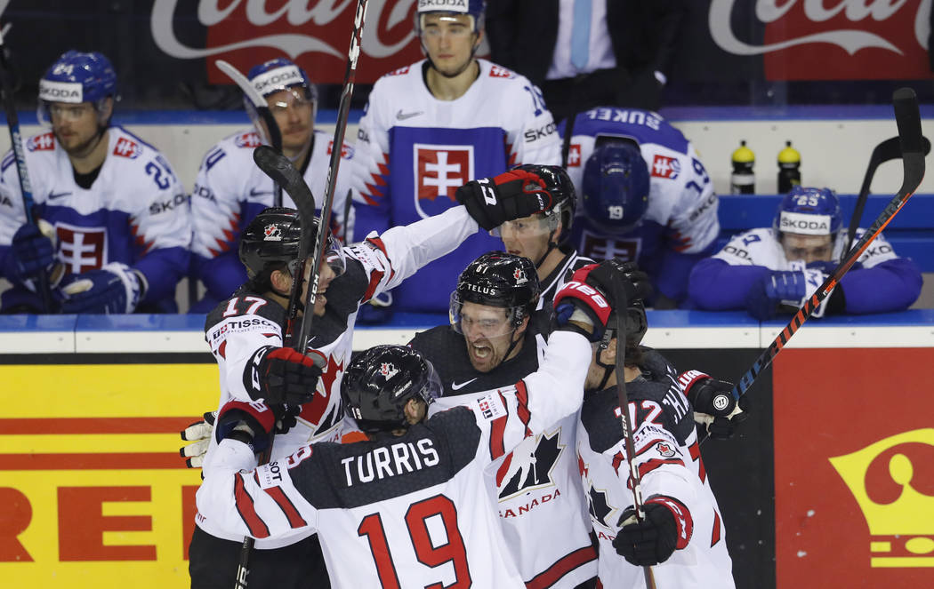 Canada's Mark Stone, center, celebrates with teammates after scoring his side's sixth goal duri ...