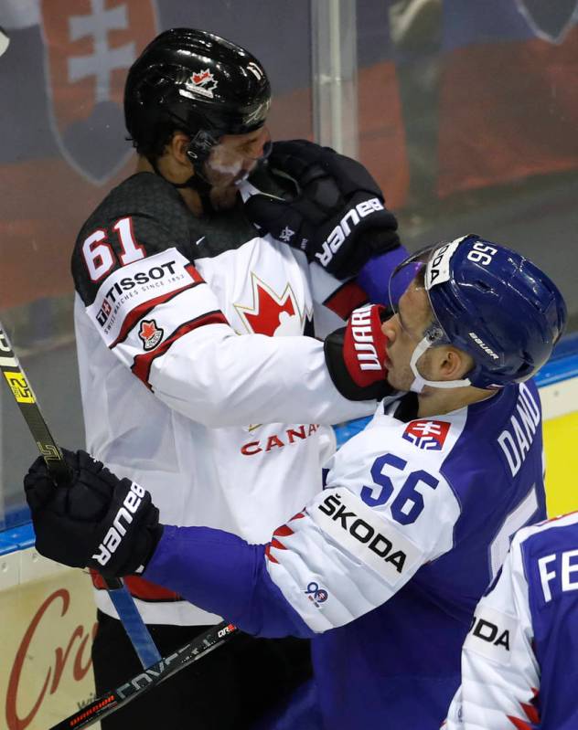 Slovakia's Marko Dano, right, punches Canada's Mark Stone, left, during the Ice Hockey World Ch ...