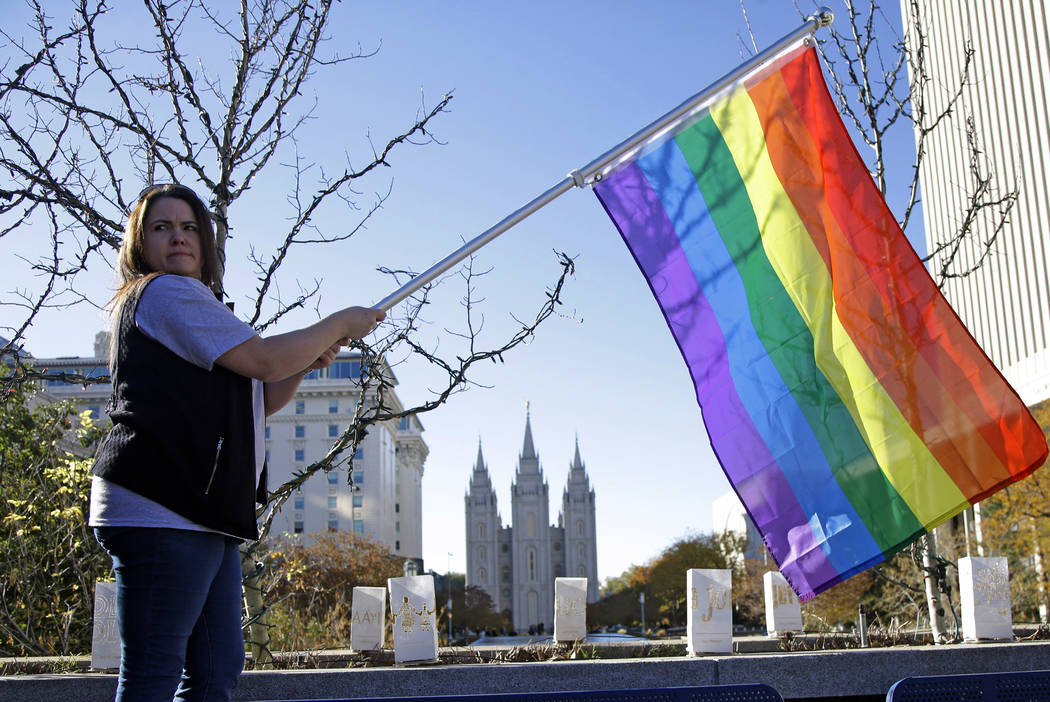 FILE - In this Nov. 14, 2015 file photo, Sandy Newcomb poses for a photograph with a rainbow fl ...