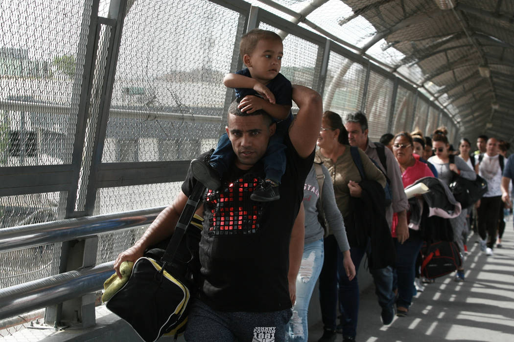 Cuban migrants are escorted by Mexican immigration officials in Ciudad Juarez, Mexico, as they ...