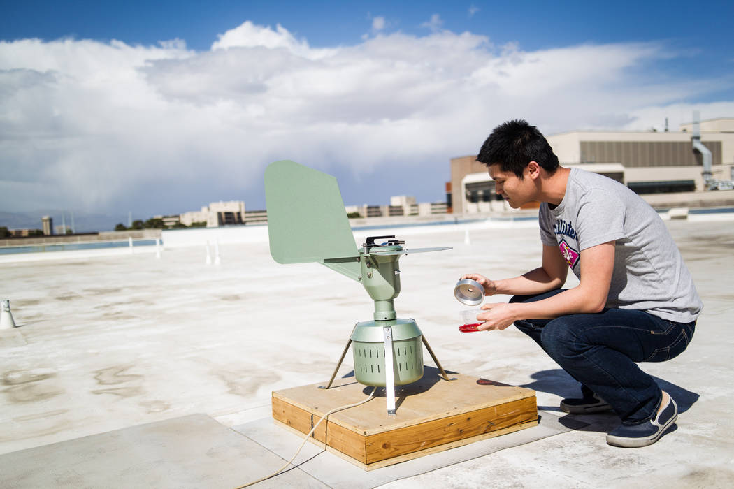 UNLV graduate student Hongbin Jin checks a pollen monitoring machine which collects samples on ...