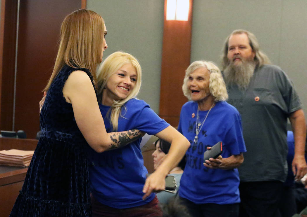 Suspended attorney Alexis Plunkett, left, congratulated by supporters, who declined to give the ...