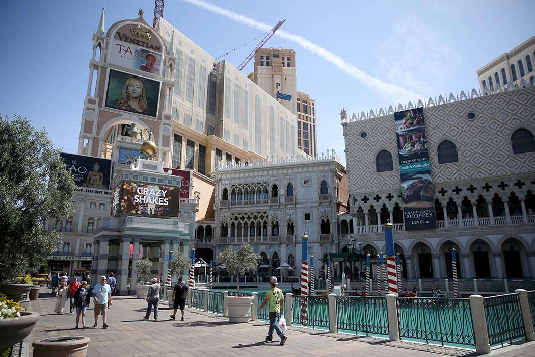 Portraits of founding employees are displayed on The Venetian marquee to celebrate the 20th ann ...