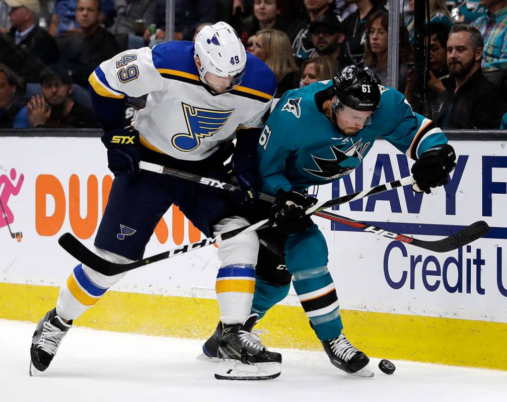 St. Louis Blues' Ivan Barbashev, left, and San Jose Sharks' Justin Braun fight for the puck dur ...