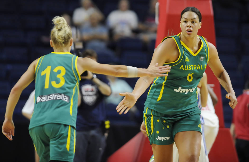 Australia's Elizabeth Cambage slaps hands with teammate Erin Phillips, left, during the first h ...