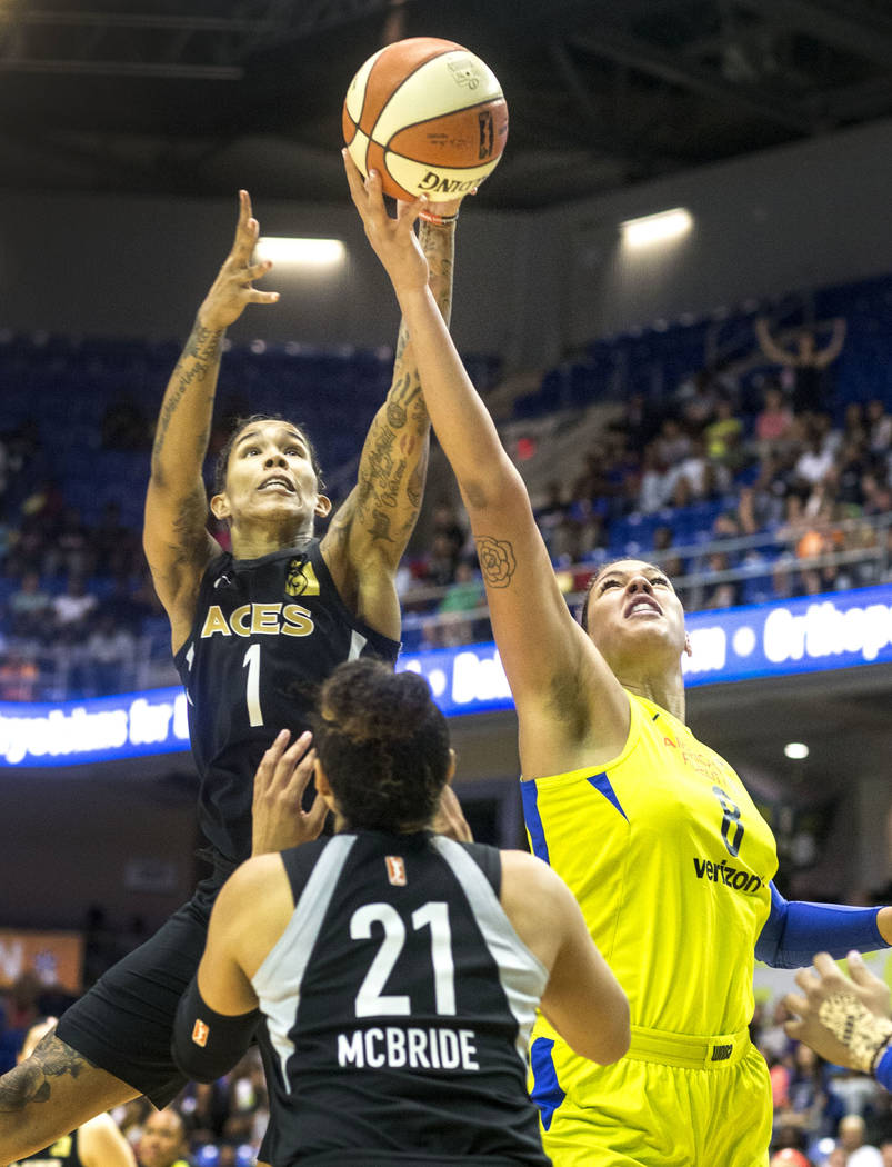 Dallas Wings center Liz Cambage (8) attempts to shoot a basket while Las Vegas forward Tamera Y ...