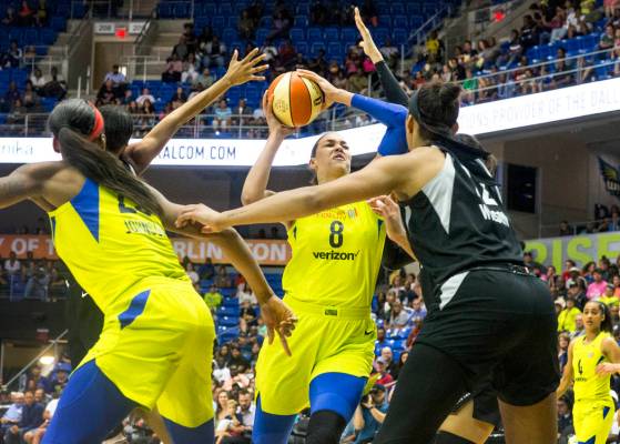 Dallas Wings center Liz Cambage (8) attempts to shoot a basket over Las Vegas forward A'ja Wils ...