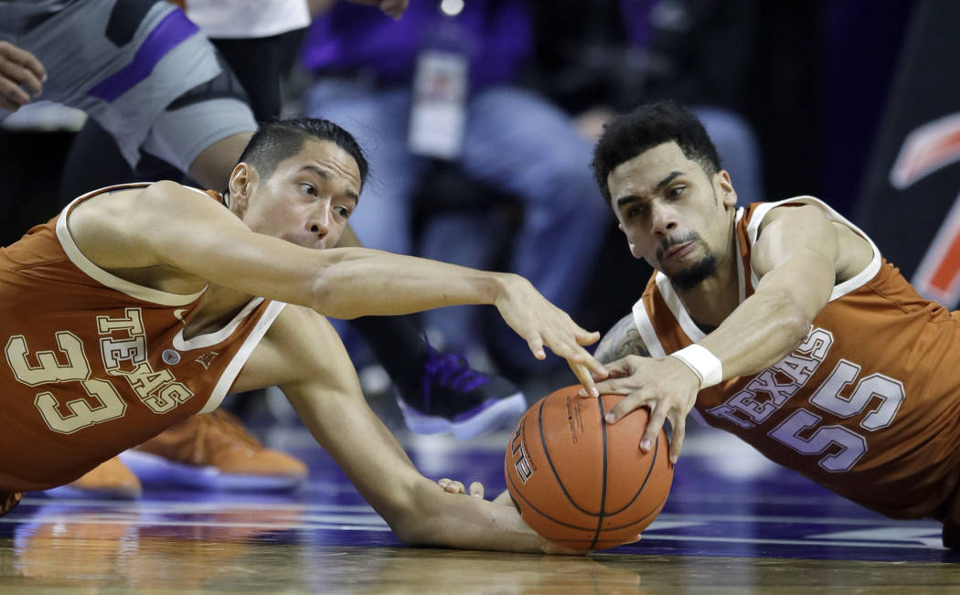 Texas forward Kamaka Hepa (33) and Texas guard Elijah Mitrou-Long (55) go to the floor for a lo ...