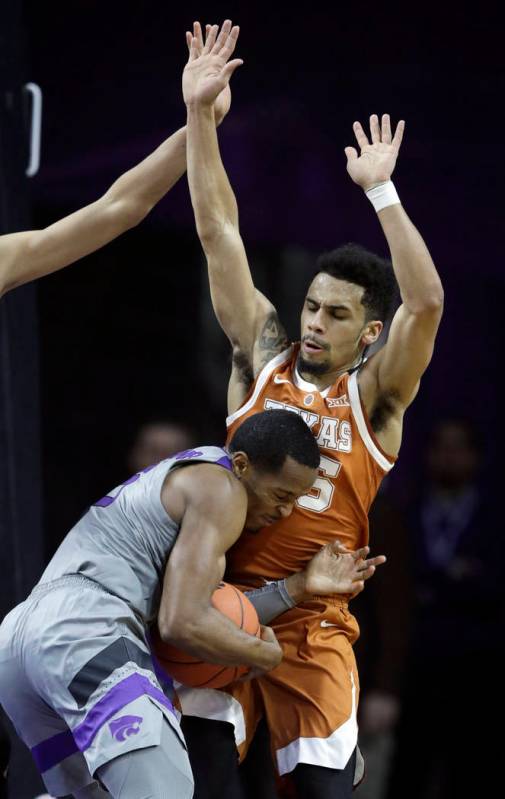 Kansas State guard Barry Brown Jr., front, runs into Texas guard Elijah Mitrou-Long, back, duri ...