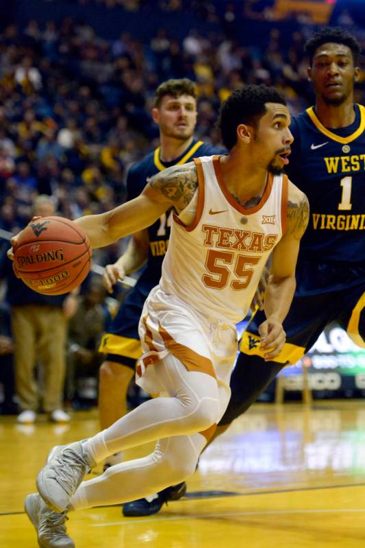 Texas guard Elijah Mitrou-Long (55) maneuvers during the first half of an NCAA college basketba ...