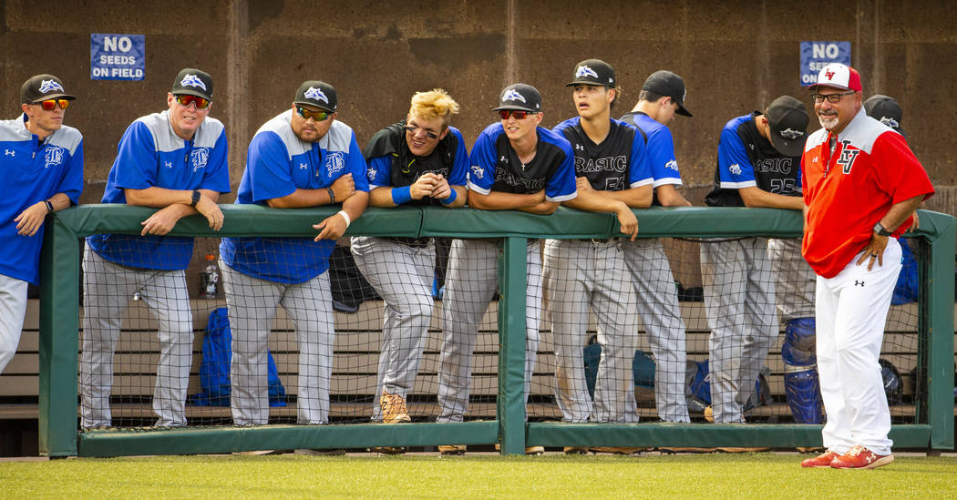 Longtime Las Vegas High coach Sam Thomas (right) talks up Basic coaches at an inning change dur ...