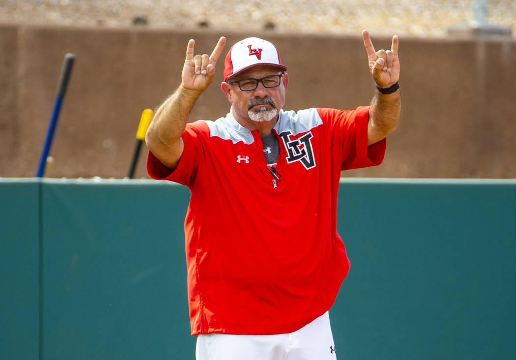 Longtime Las Vegas High coach Sam Thomas signals a player at first base during their state base ...