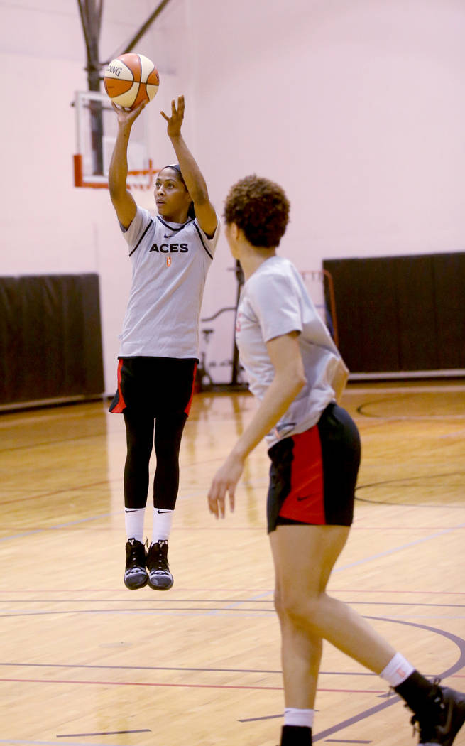 Veteran guard Sydney Colson shoots over Isabelle Harrison during practice at the Cox Pavilion i ...