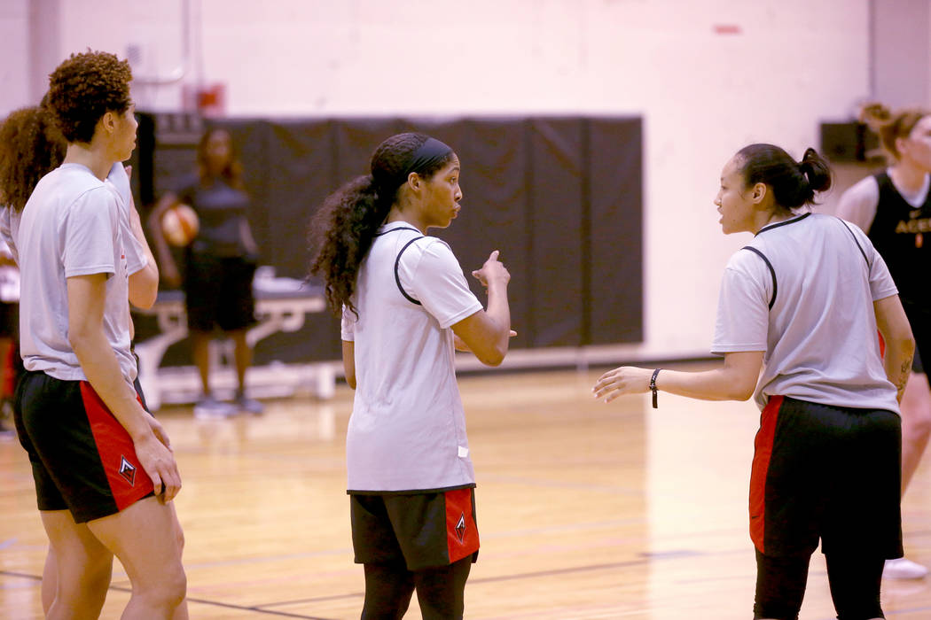 Veteran guard Sydney Colson, center, talks to teammate Saniya Chong during practice at the Cox ...