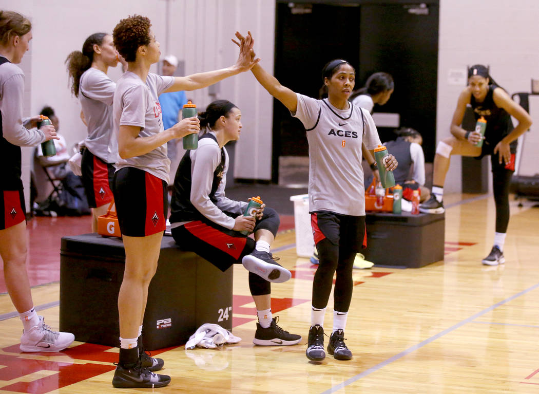 Veteran guard Sydney Colson, right, high-fives Isabelle Harrison during practice at the Cox Pav ...