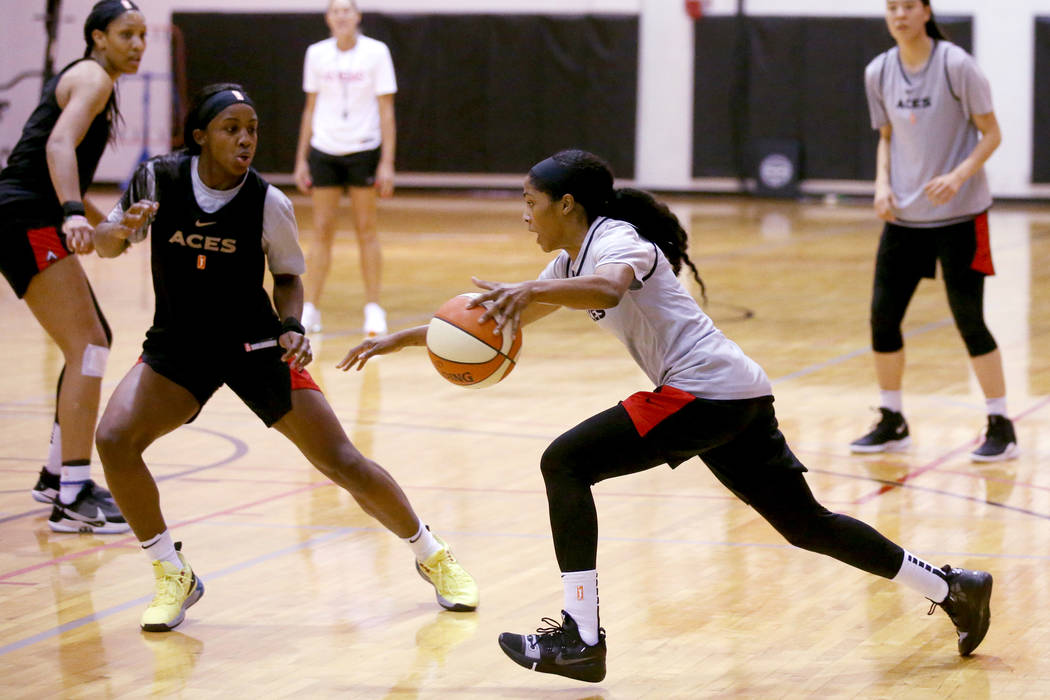 Veteran guard Sydney Colson drives on Jackie Young as A'ja Wilson, left, and JiSu Park look on ...