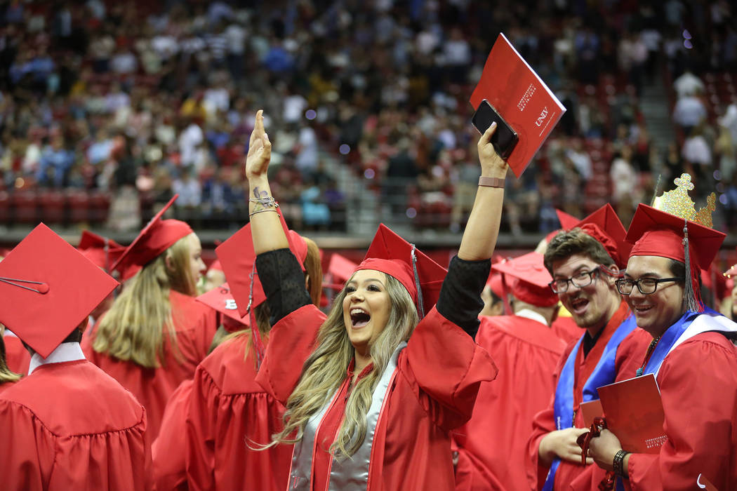 Psychology major Sharon Kotler, 23, center, of Las Vegas, celebrates at the end of the program ...