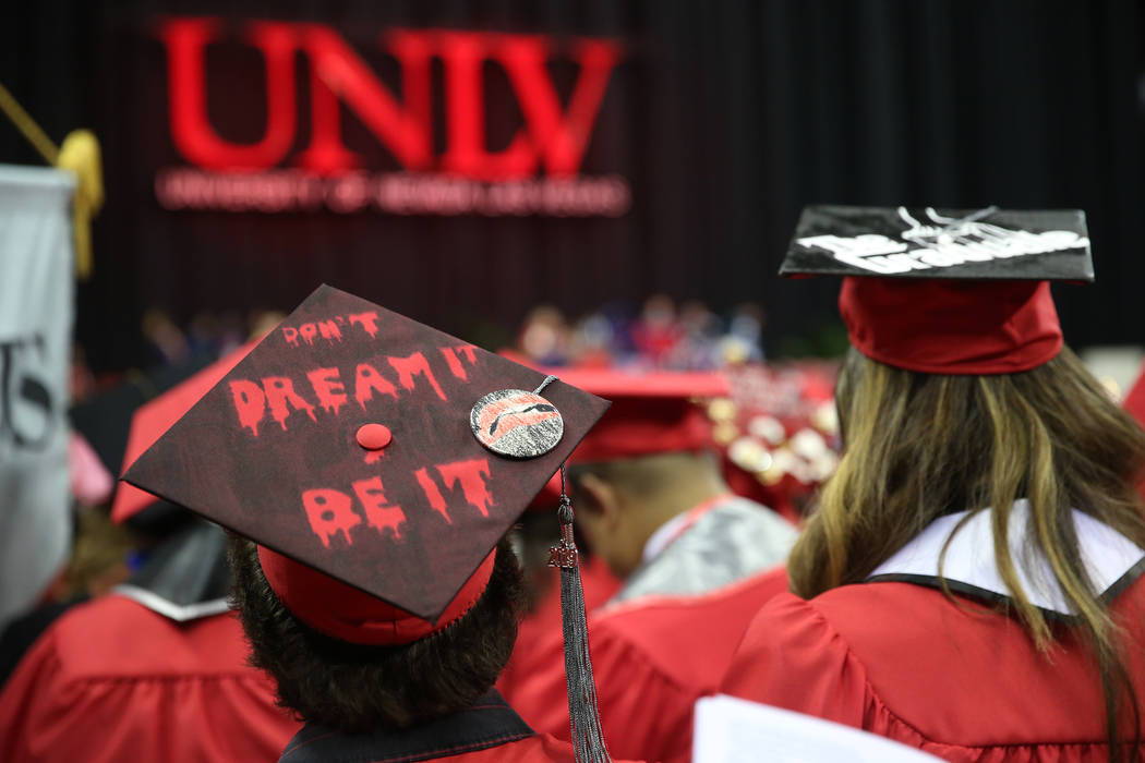 Graduates attend the UNLV commencement ceremony at the Thomas & Mack Center in Las Vegas, S ...