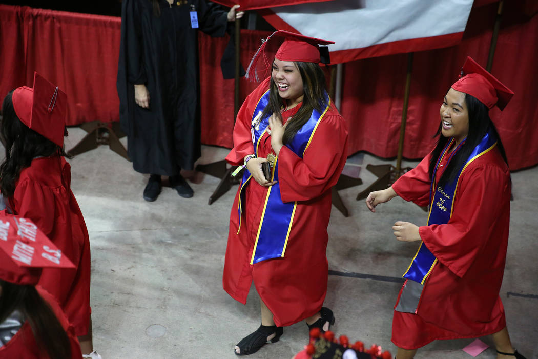 Graduates attend the UNLV commencement ceremony at the Thomas & Mack Center in Las Vegas, S ...