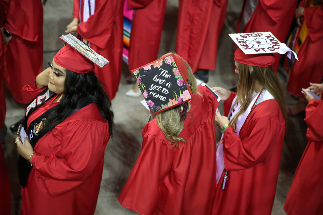 Graduates attend the UNLV commencement ceremony at the Thomas & Mack Center in Las Vegas, S ...