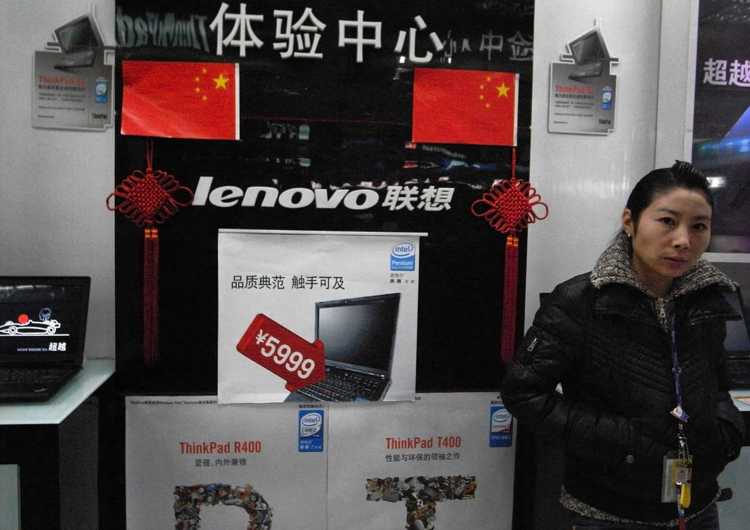 FILE - In this Jan 8, 2009, file photo, a vendor waits for customers at a computer shop selling ...