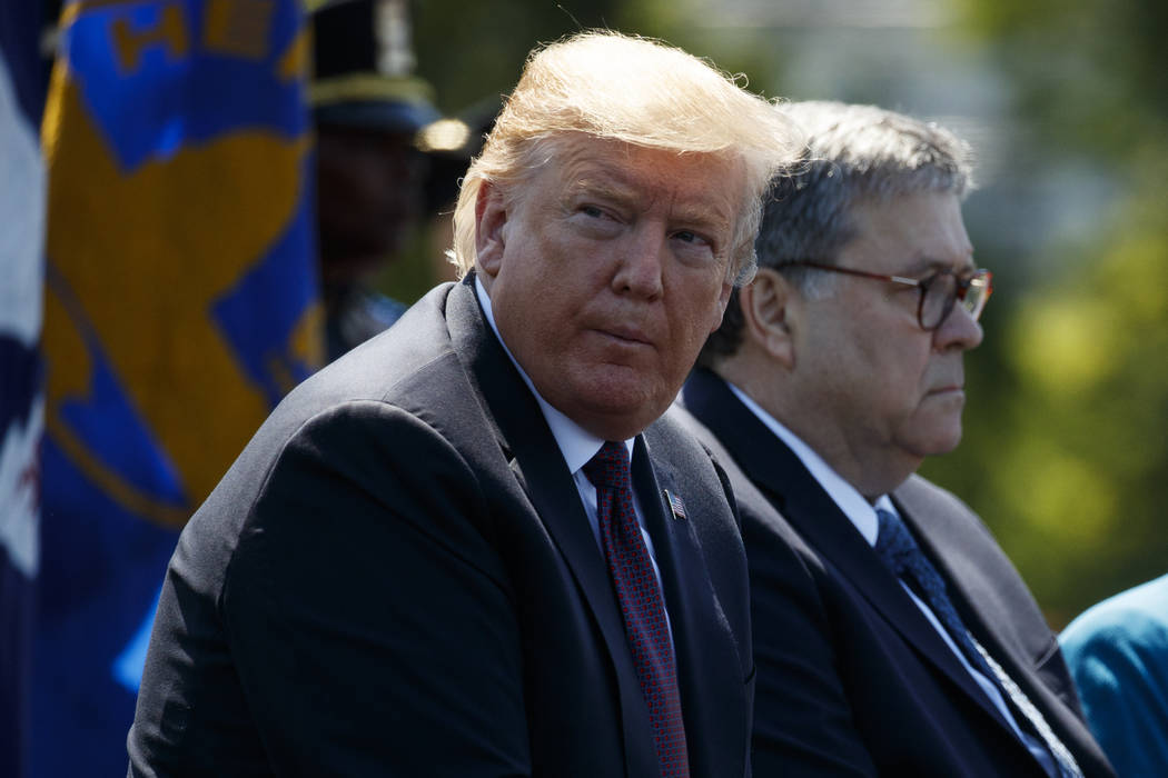 President Donald Trump sits with Attorney General William Barr during the 38th Annual National ...