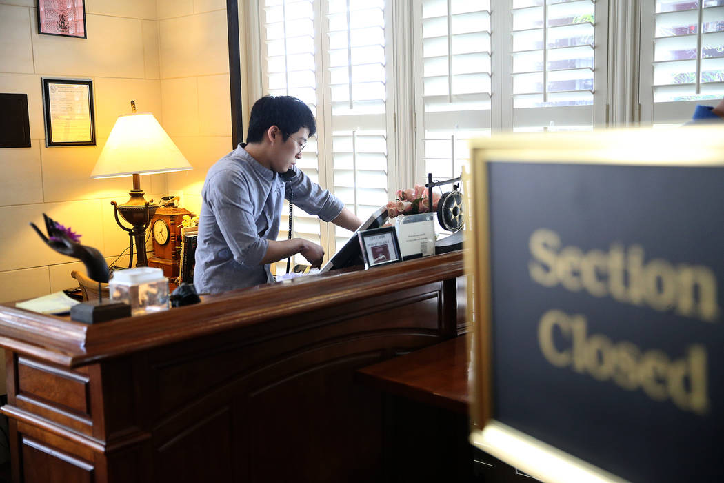 Bistro manager Isaphong Phonchana takes a call at Archi's Thai Bistro in Las Vegas, Thursday, M ...