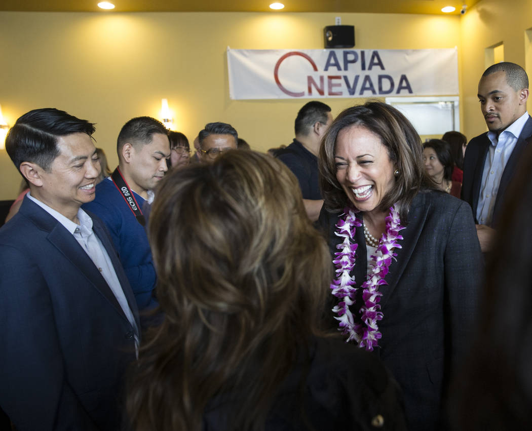 Presidential candidate Sen. Kamala Harris, right, D-Calif., speaks with guests during a meet an ...