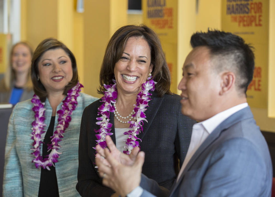 Presidential candidate Sen. Kamala Harris, center, D-Calif., shares a laugh with guests includi ...