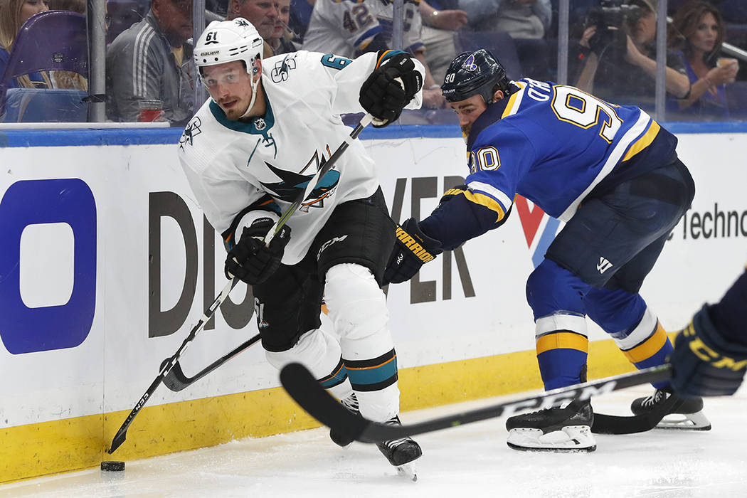 San Jose Sharks defenseman Justin Braun (61) moves the puck ahead of St. Louis Blues center Rya ...