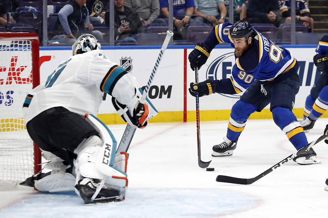 St. Louis Blues center Ryan O'Reilly (90) closes in on San Jose Sharks goaltender Martin Jones, ...