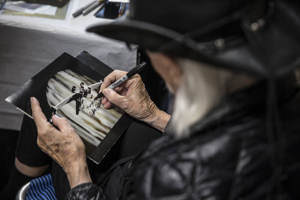 Colin Cantwell, concept artist and model builder for the original Star Wars movies, signs a pho ...