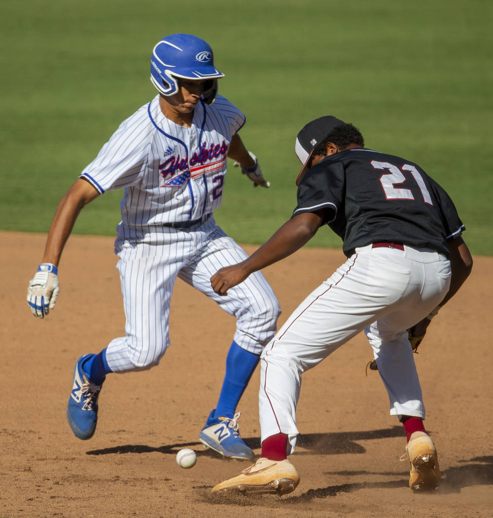 Reno's Skylar Hales (24) scurries safely back to first base after a bad throw to Desert Oasis' ...