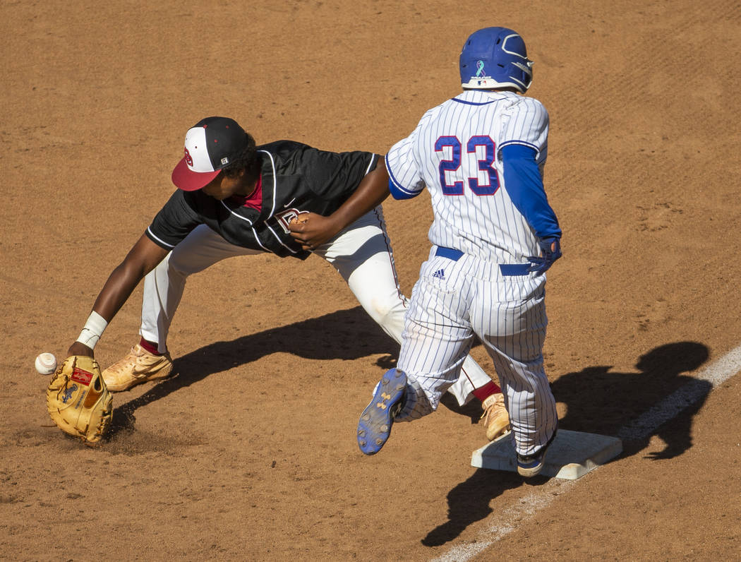 Desert Oasis' Jacob Walsh (21) gets the ball late as Reno's Ryan Hess (23) hustles to first bas ...