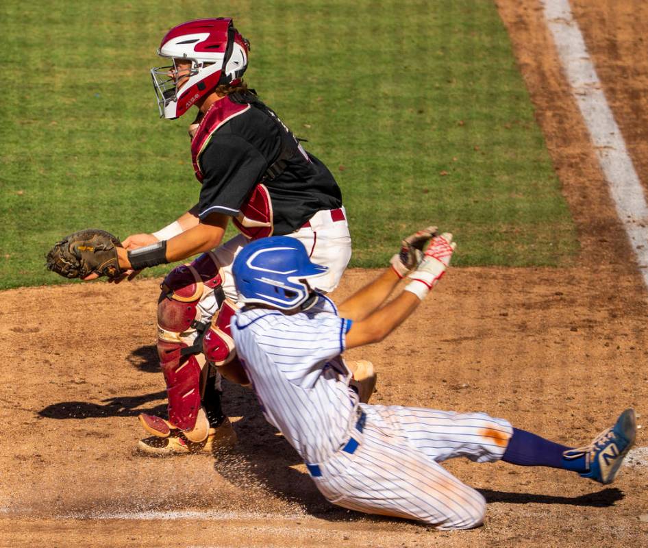 Desert Oasis catcher Parker Schmidt (4) waits for a late throw as Reno's Garrett Damico (3) sco ...