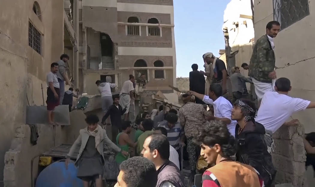 In this frame grab from from video, people search in the rubble following Saudi-led coalition a ...